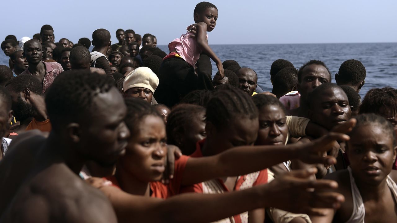 Migrants wait to be rescued.
