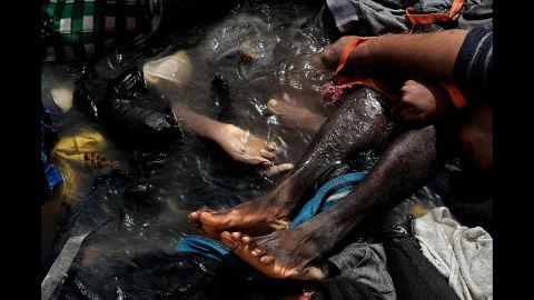 The bodies of refugees and migrants who died on a rubber boat lie on a boat in the Mediterranean Sea on October 5.