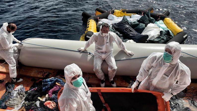 Members of Proactiva Open Arms move the bodies of 29 migrants to a life boat. <a href="index.php?page=&url=http%3A%2F%2Fwww.cnn.com%2F2015%2F08%2F28%2Fworld%2Fiyw-migrant-how-to-help%2Findex.html" target="_blank">How to help the ongoing migrant crisis</a>