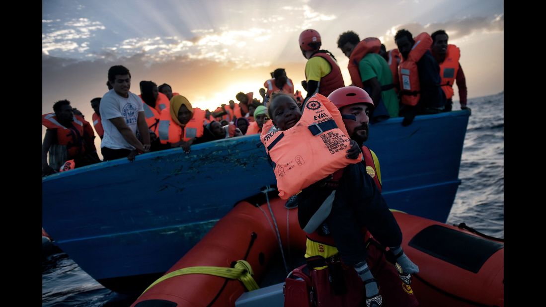 A child is rescued by a member of Proactiva Open Arms.