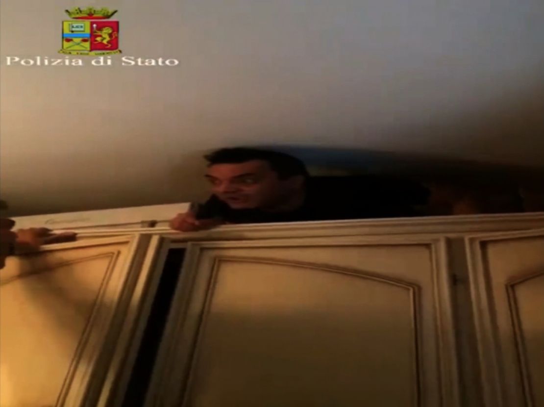 Italian mafia boss Antonio Pelle emerges from his cupboard hideout.