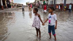 Girls hold hands as they help each other wade through a flooded street after the passing of Hurricane Matthew in Les Cayes, Haiti, Thursday, October 6. Two days after the storm rampaged across the country's remote southwestern peninsula, authorities and aid workers still lack a clear picture of what they fear is the country's biggest disaster in years. 