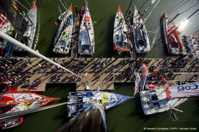 Competitors race in powerful Imoca Open 60 yachts.