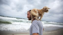 Ted Houston and his dog Kermit visit the beach as Hurricane Matthew approaches the area on Thursday, October 6 in Palm Beach Florida.  T