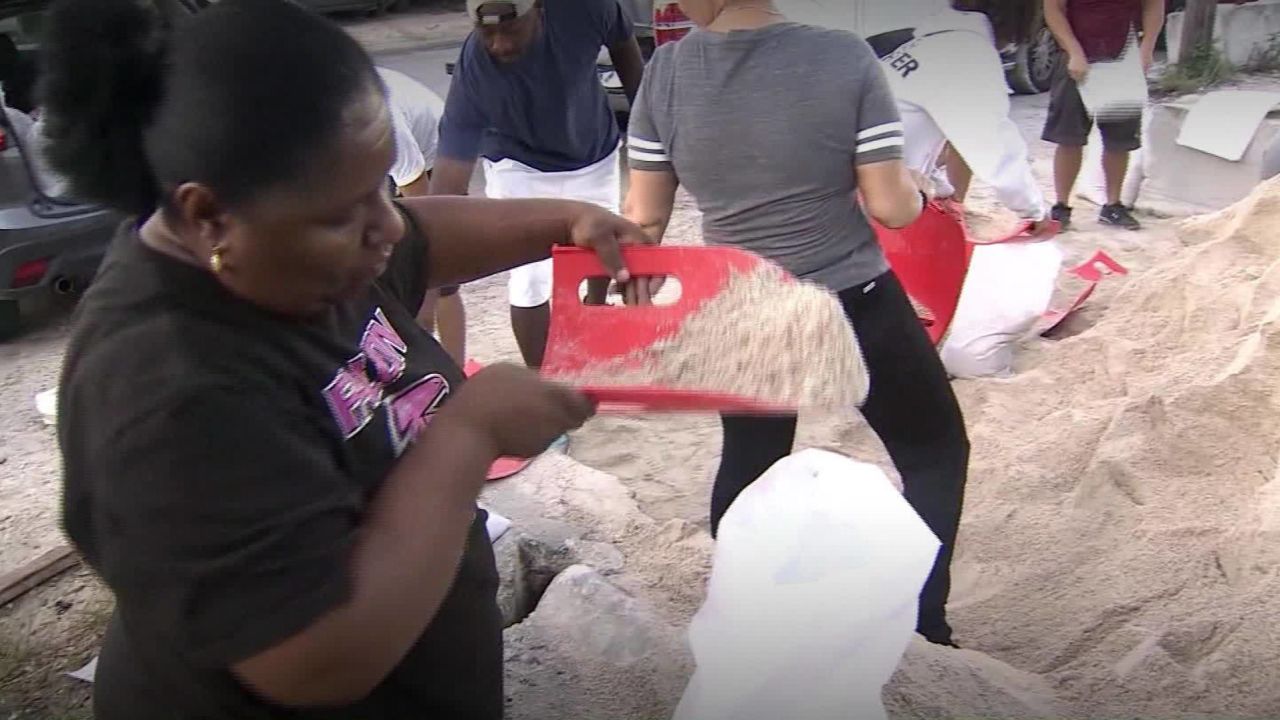 Daytona Beach residents fill sandbags Thursday.