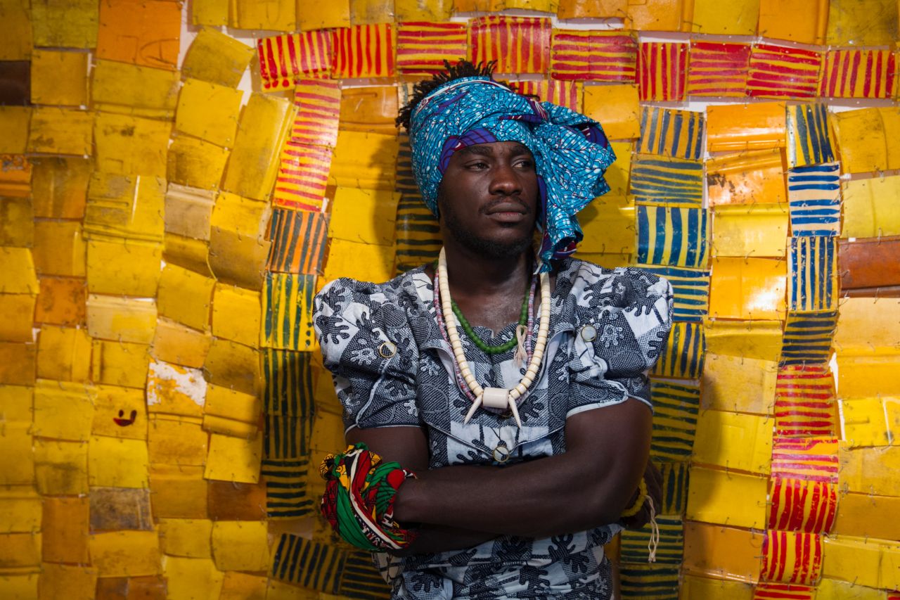 Ghanaian born Clottey often dresses up in women's clothes in public street performances with his 70 strong collective who take part in his public art performances. 