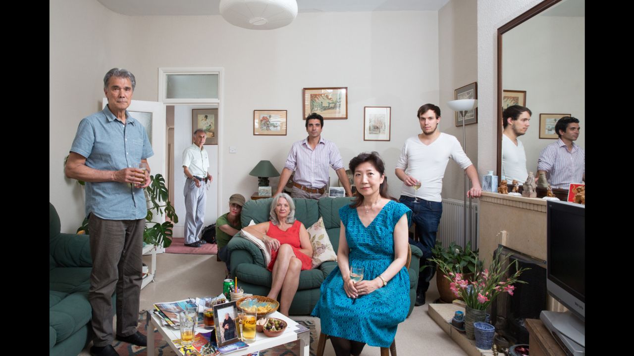 A portrait of photographer Chris Steele-Perkins and his family in London. Steele-Perkins is standing in the doorway.