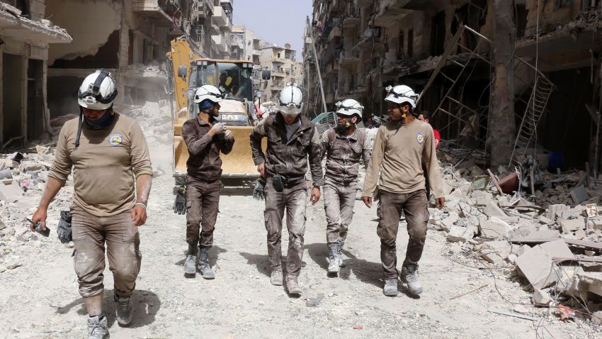 Syrian civil defence volunteers, known as the White Helmets, walk amidst the debris following a reported air strike by Syrian government forces in the rebel-held neighbourhood of Sukkari in the northern city of Aleppo on June 3, 2016.
Regime air strikes killed dozens of civilians in the Syrian city of Aleppo and nearby areas as the UN Security Council prepared to discuss emergency aid drops to besieged areas. / AFP / THAER MOHAMMED (Photo credit should read THAER MOHAMMED/AFP/Getty Images)