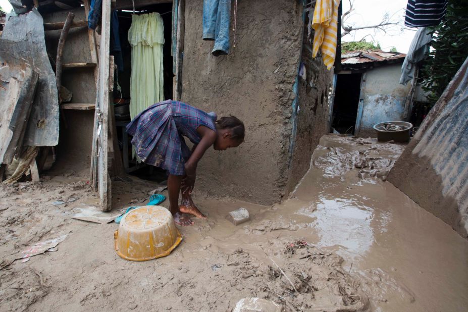A girl washes mud from her feet after Hurricane Matthew passed through Les Cayes, Haiti, on October 6.