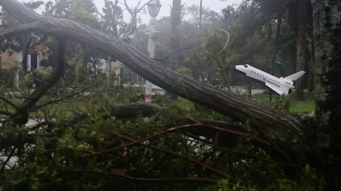 A space shuttle model stands near some downed trees after Hurricane Matthew passed by Cocoa Beach.