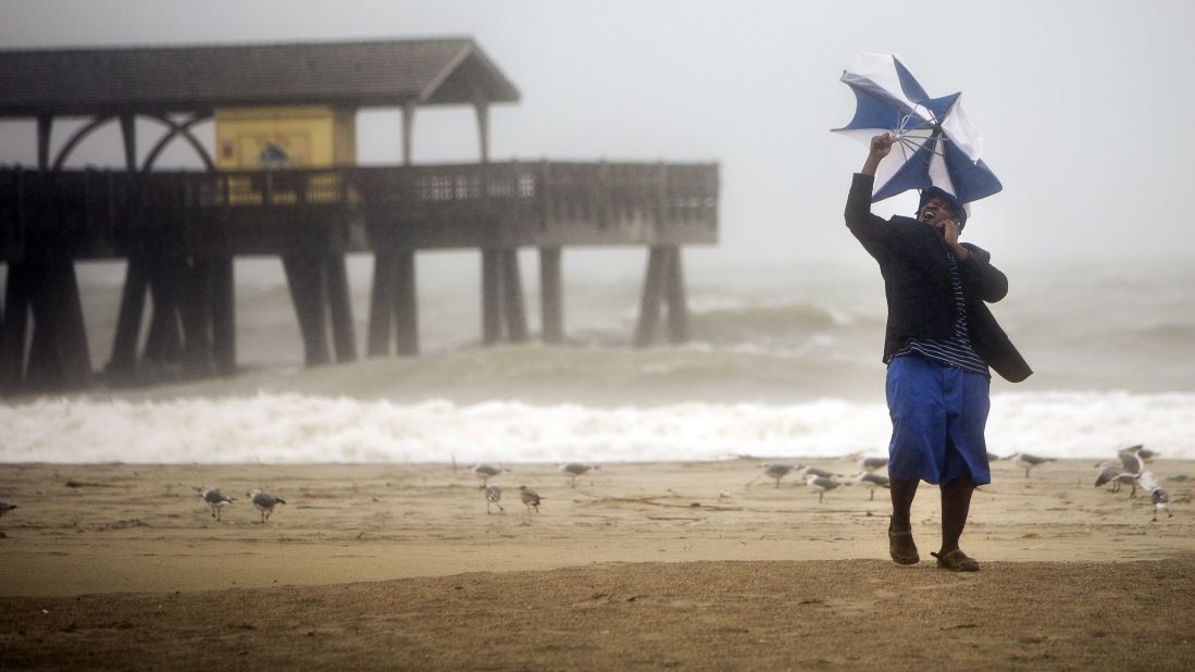 Preston Payne tries to hold his umbrella on Georgia's Tybee Island on October 7.