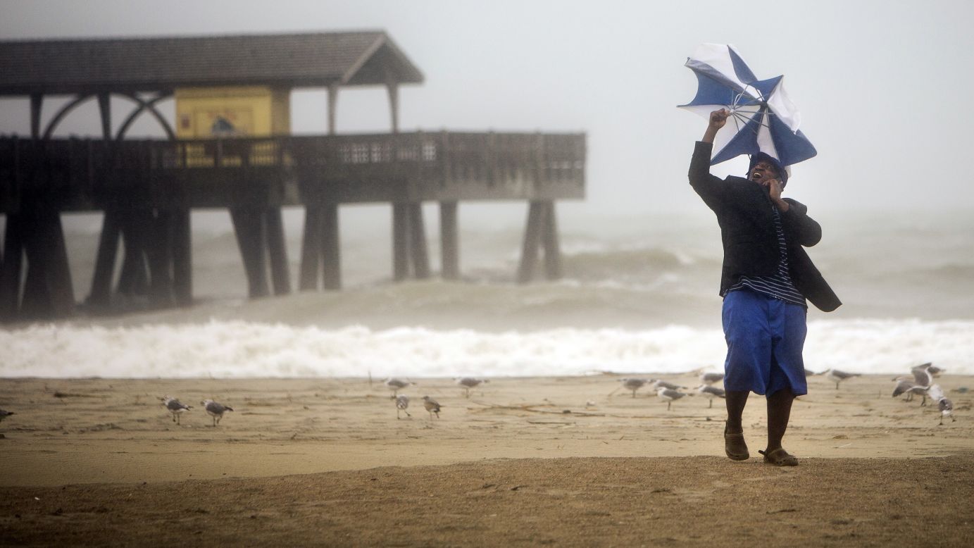 Preston Payne tries to hold his umbrella on Georgia's Tybee Island on October 7.