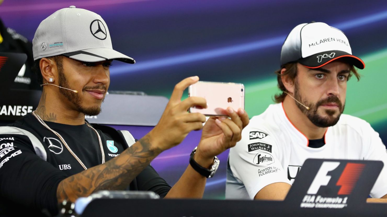 Lewis Hamilton plays with his phone in a press conference ahead of the Japan Grand Prix in Suzuka.