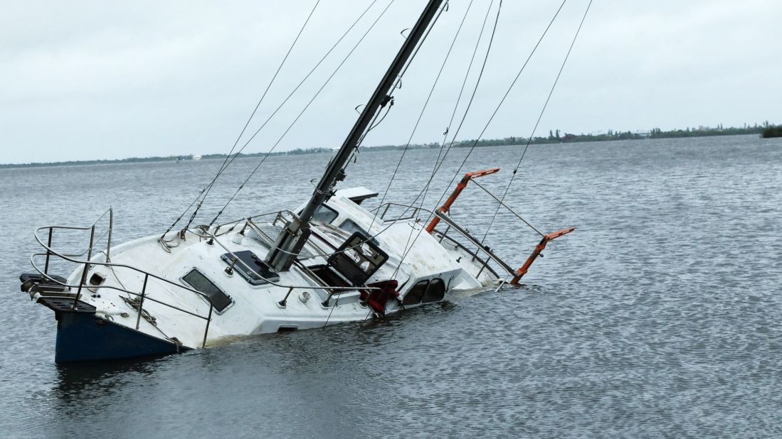 A damaged boat sits partially submerged on the intercoastal waterway in Melbourne, Florida, on October 7.