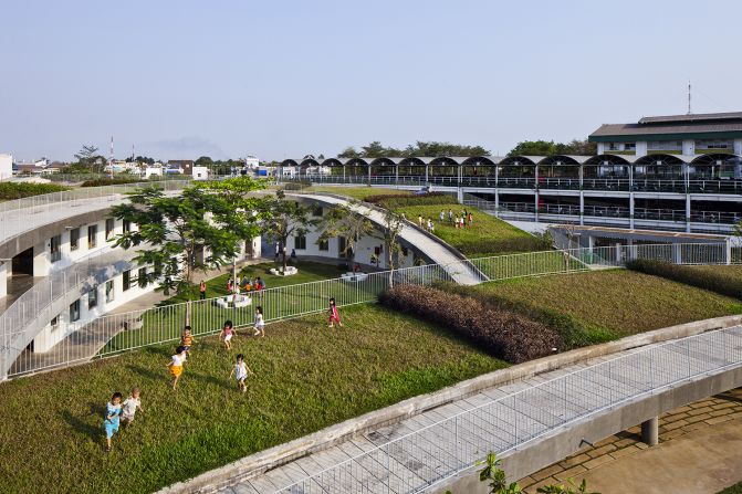 Built for 500 children of the neighboring factory's workers, the building has a large green roof which becomes an extensive open playground.