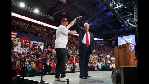 Peter Riehl, of Lone Tree, Colorado, holds up the hand of Republican presidential candidate Donald Trump during a campaign rally in Loveland, Colorado, on Monday, October 3.