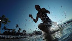 KAILUA KONA, HAWAII - OCTOBER 10:  An athlete exists the water after the 2.4-mile/3.8km swim during the IRONMAN World Championship presented by GoPro on October 10th 2015, Kailua Kona, Hawaii. (Photo by Hugh Gentry/IRONMAN) IRONMAN Triathlon consists of a 2.4-mile (3.86 km) swim, a 112-mile (180.25 km) bicycle ride and a marathon 26.2-mile (42.2 km) run. IRONMAN is considered one of the most difficult endurance events in the world.