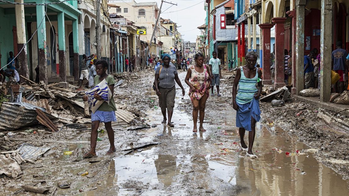 People walk through their destroyed town of Jeremie, Haiti on Thursday October 6.
