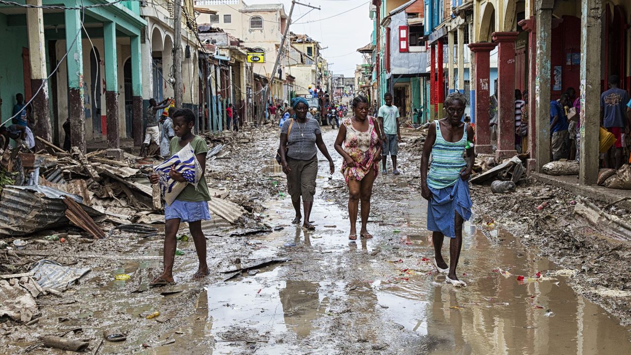 People walk through the devastated town of Jeremie on Thursday.