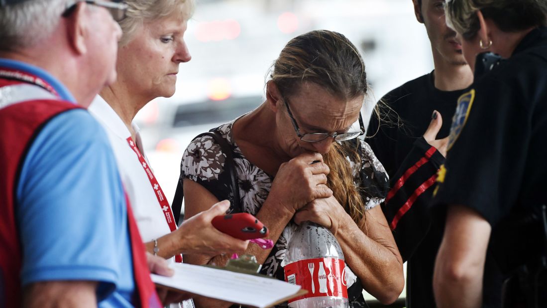 A police officer helps persuade a woman to board a bus and evacuate Savannah, Georgia, on October 7.