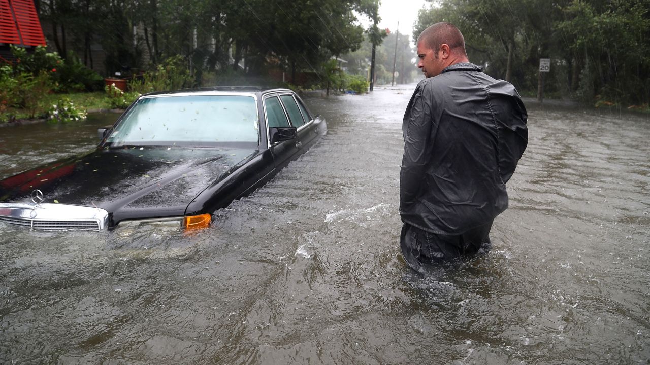 Nick Lomasney walks on a flooded street in St Augustine, Florida.