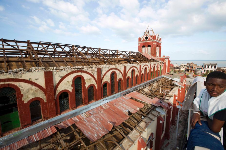 A young man stands near the cathedral damaged by Hurricane Matthew, in Jeremie, Haiti, on October 7.