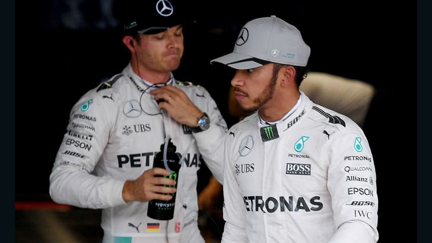 Mercedes AMG Petronas F1 Team's British driver Lewis Hamilton (R) walks in front of his teammate Mercedes AMG Petronas F1 Team's German driver Nico Rosberg after the qualifying session at the Formula One Japanese Grand Prix in Suzuka on October 8, 2016. / AFP / TOSHIFUMI KITAMURA        (Photo credit should read TOSHIFUMI KITAMURA/AFP/Getty Images)