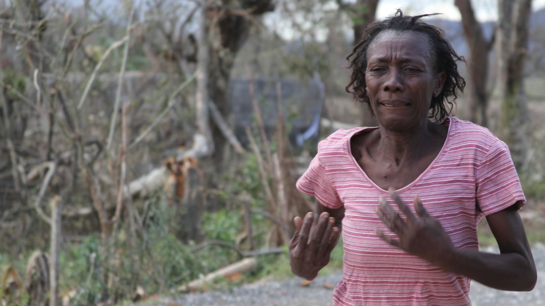 A woman runs in the streets seeking aid in the aftermath of Hurricane Matthew in Haiti.