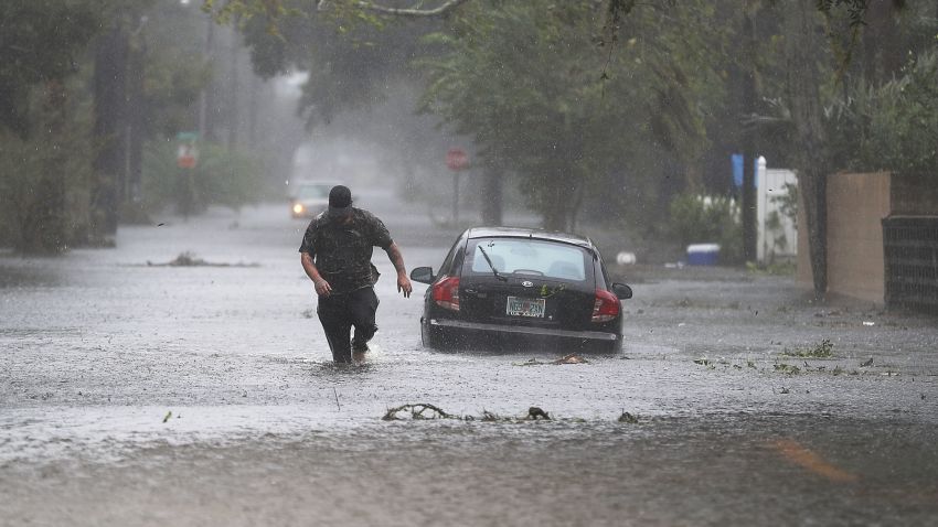 ST AUGUSTINE, FL - OCTOBER 07: Justin Dossett walks through a flooded street as Hurricane Matthew passes through the area on October 7, 2016 in St Augustine, Florida. Florida, Georgia, South Carolina and North Carolina all declared a state of emergency in preparation of Hurricane Matthew. (Photo by Joe Raedle/Getty Images)