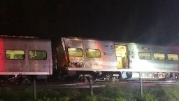 In this photo provided by Sarah Qamar shows a Long Island Railroad train derailed near New Hyde Park, N.Y., Saturday, Oct. 8, 2016.  The commuter train derailed east of New York City after it hit a work train on the tracks. A spokesman for the Long Island Rail Road says the eastbound train derailed east of New Hyde Park just after 9 p.m. Saturday. A spokeswoman for the Nassau County Police Department says there are 50 to 100 injuries, none of them life-threatening. (Sarah Qamar via AP)