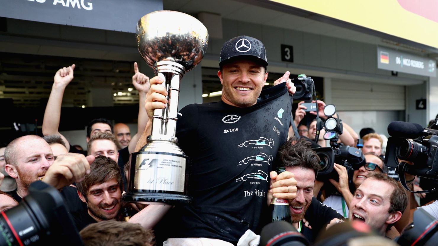 Nico Rosberg celebrates his victory at Suzuka with his Mercedes team which has sealed the Constructors' crown. 