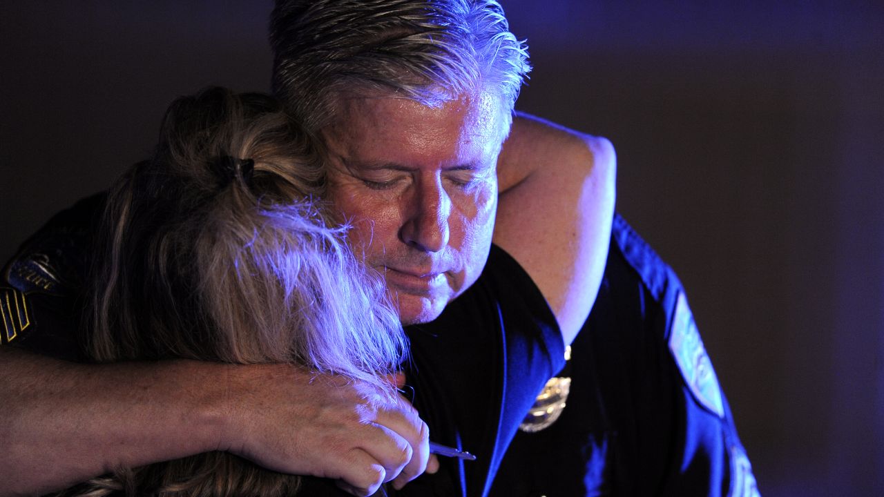 Palm Springs peace officers hug each other at Desert Regional Medical Center on Saturday night.