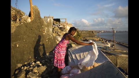 Andrenne Joseph dries her clothes near the remains of her house in Jeremie on October 8.