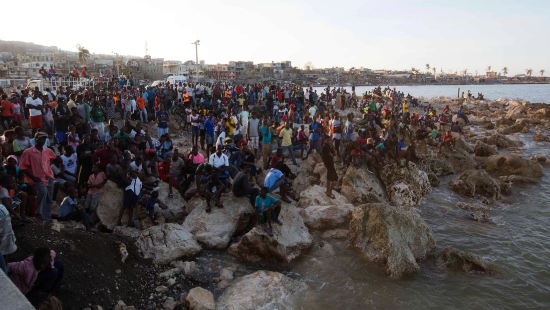 Residents of Jeremie wait on the shore October 8 as a boat with water and food from the "Mission of Hope" charity arrives. Jeremie appears to be the epicenter of Haiti's growing humanitarian crisis in the wake of the storm.