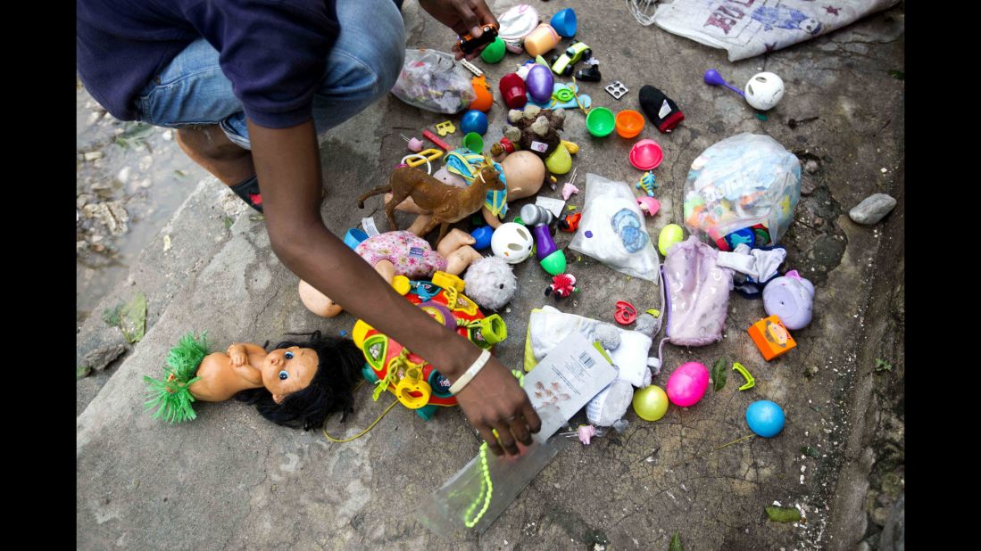 A man dries toys recovered from the debris left by Hurricane Matthew in Les Cayes, Haiti, on Thursday, October 6. 