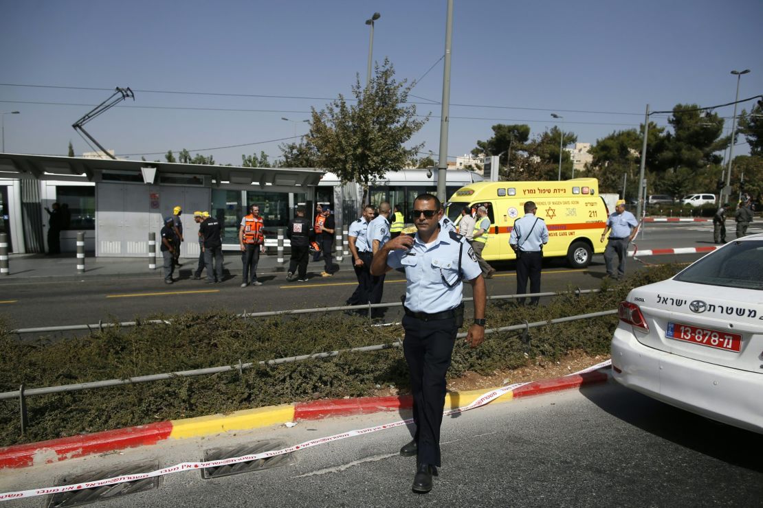 Israeli security forces and policemen gather at the scene of the attack.