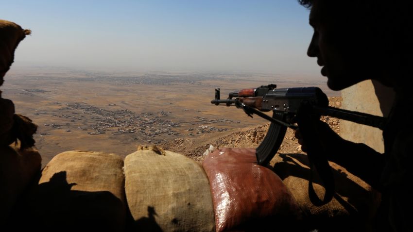 Iraqi Kurdish Peshmerga fighters hold a position on the top of Mount Zardak, about 25 kilometres east of Mosul.