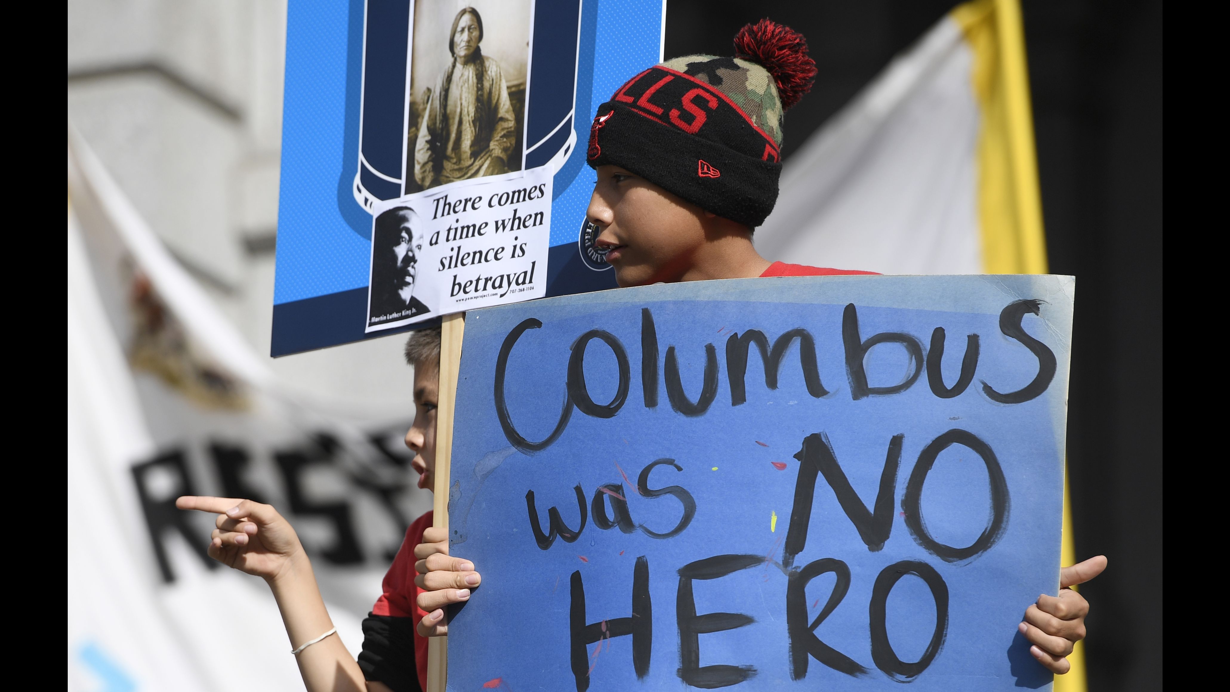 Young demonstrators protest a Columbus Day parade in Denver on Saturday. 