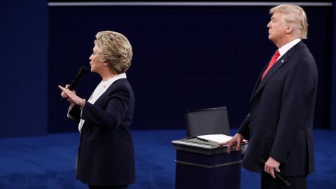 Hillary Clinton speaks as Republican presidential nominee Donald Trump looks on during the town hall debate at Washington University on October 9 in St Louis, Missouri.