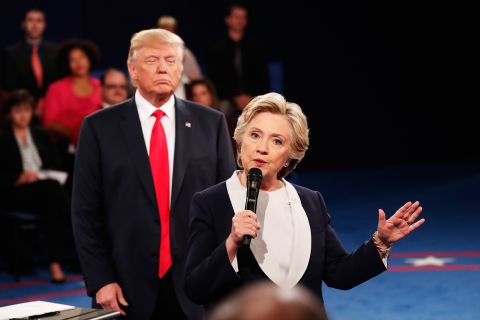 Trump looks on as Clinton answers a question.