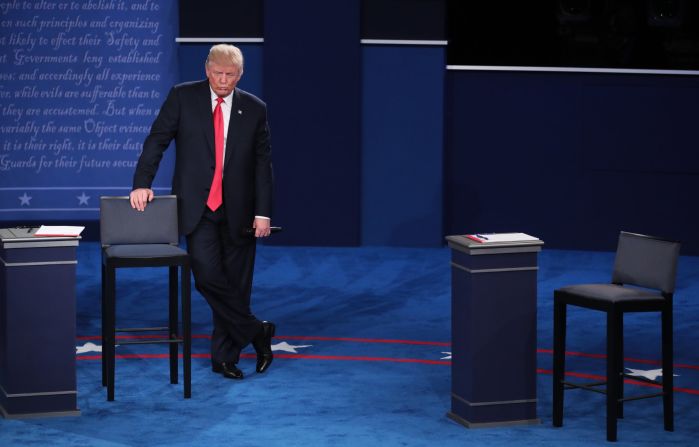 Trump leans against a chair during the debate.