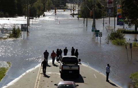 People stop and take pictures of Highway 58, which was flooded in Nashville, North Carolina, on October 9.