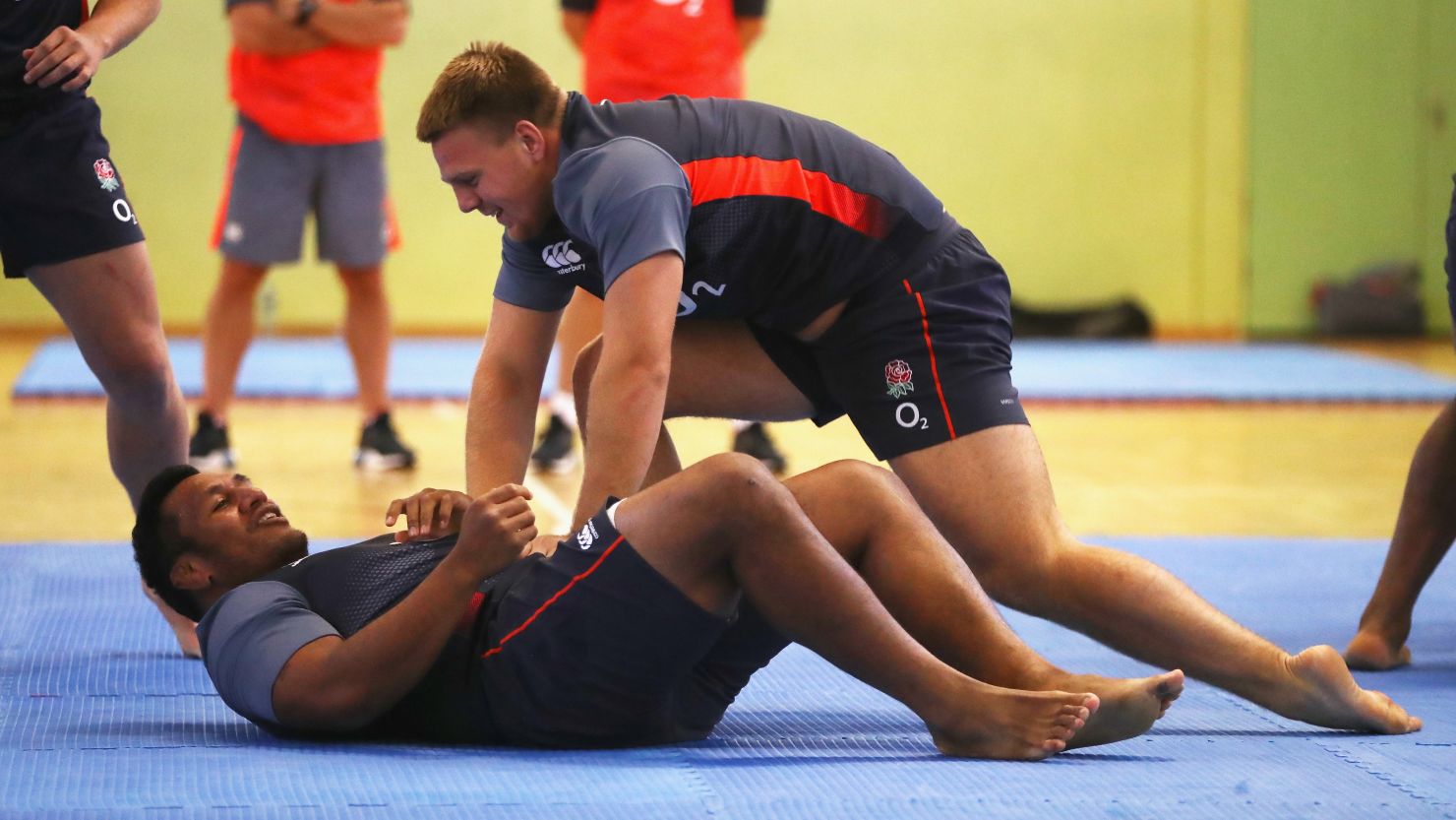 Mako Vunipola is held down by England teammate Paul Hill during a judo session.