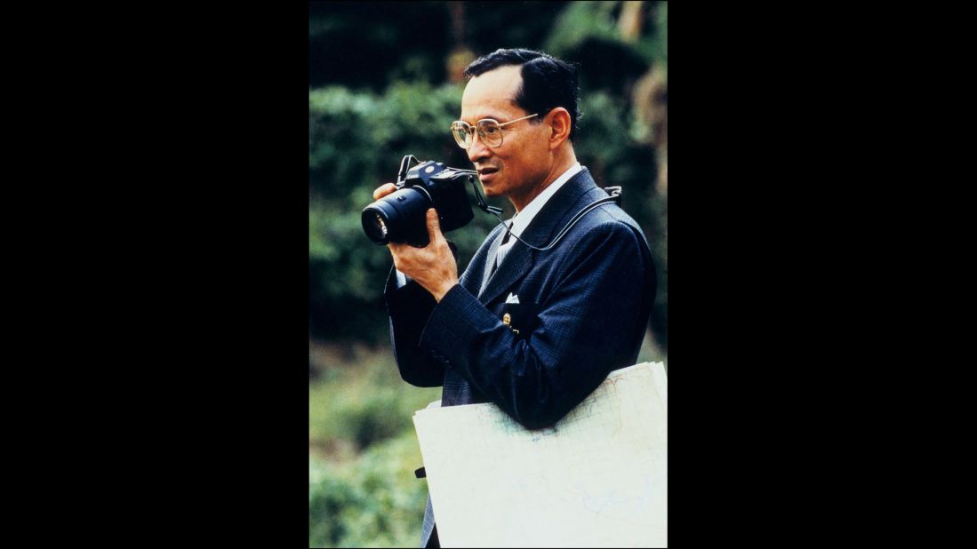 The King raises a camera to take a photo in 1995. He was given his first camera in 1934, which ignited a lifelong enthusiasm for photography. He has often been seen with a camera around his neck during public appearances.