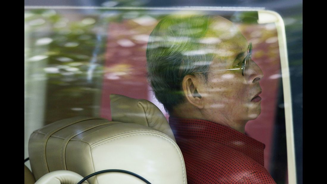 The King is seen through a car window as he leaves the Siriraj hospital in Bangkok in 2015.