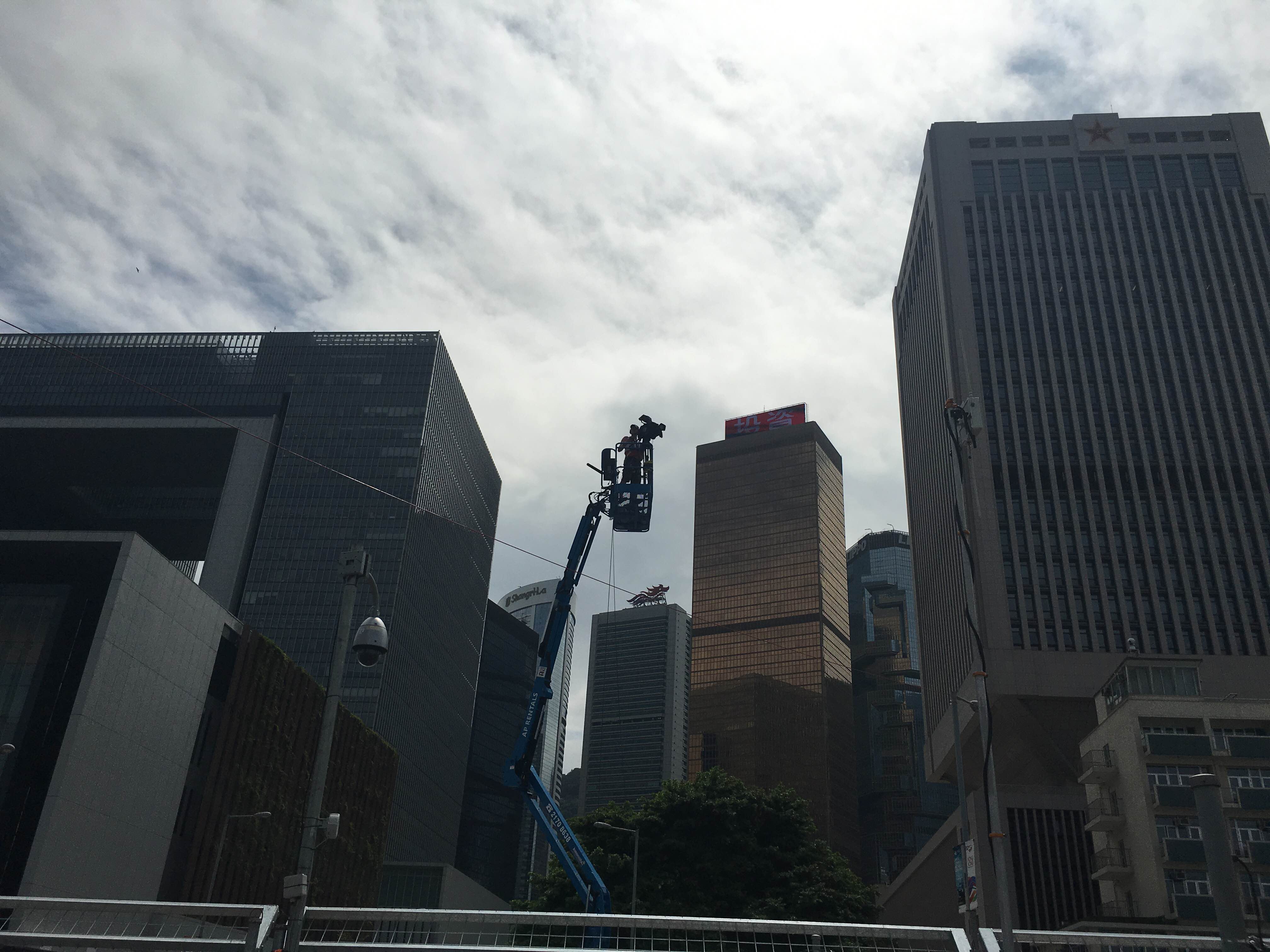A cameraman films the action from above the track.