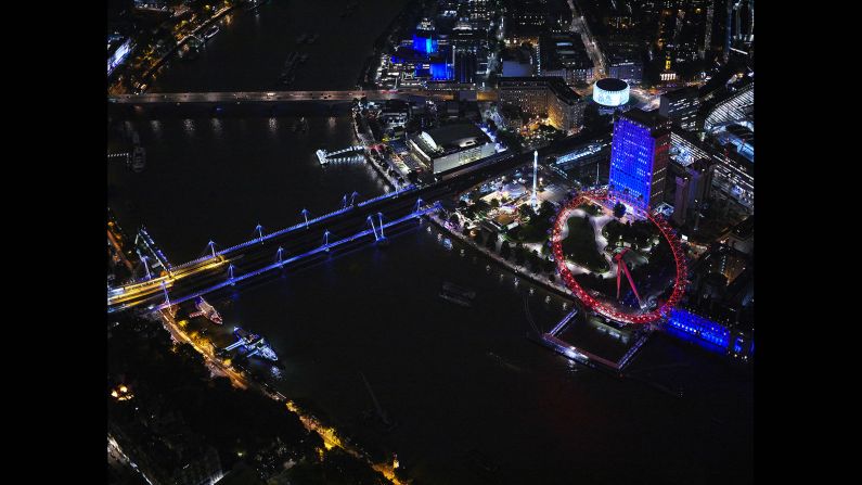 He achieves these remarkable images by hanging out of a helicopter as it zooms over the UK capital. Here we see the London Eye and Hungerford and Golden Jubilee Bridges. 