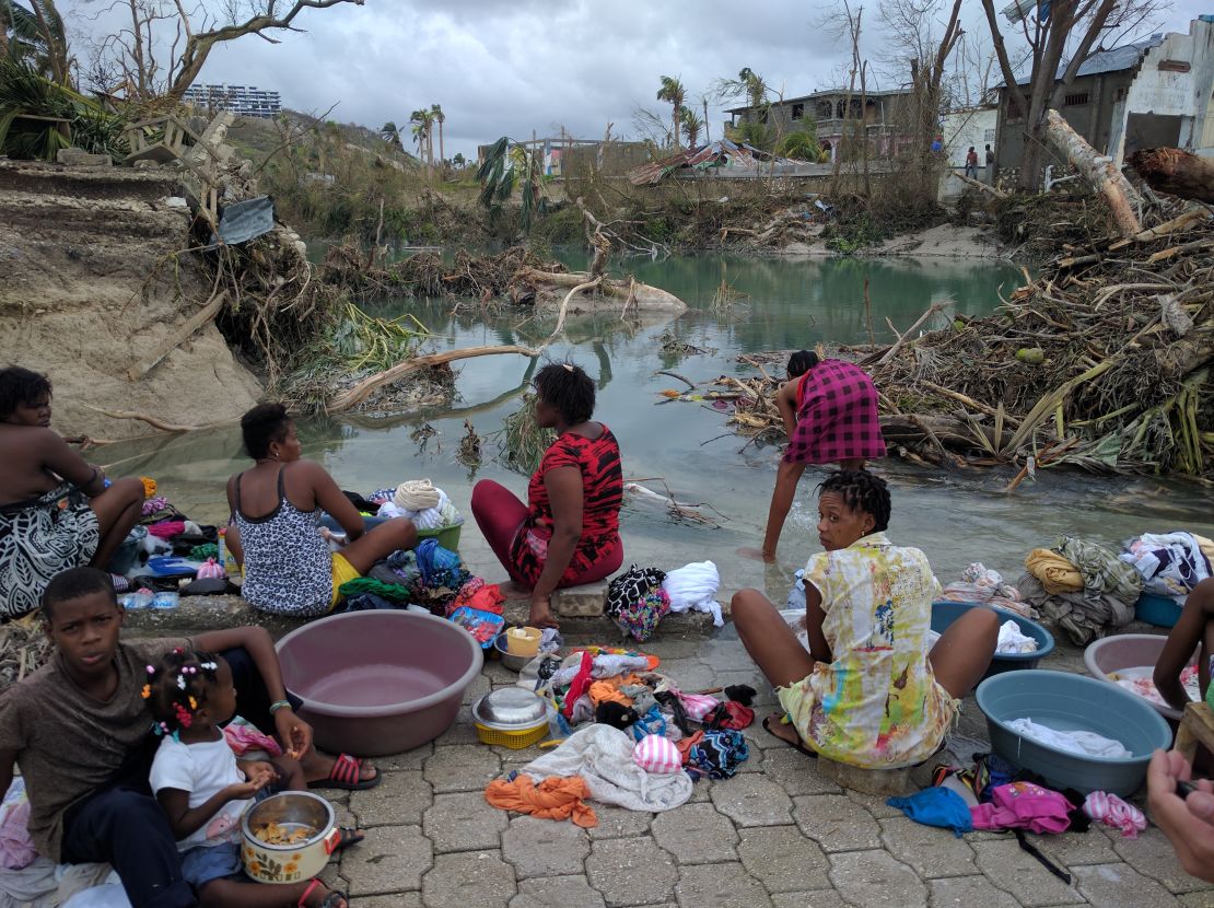 Women and children wash clothes in the aftermath of the devastating hurricane.