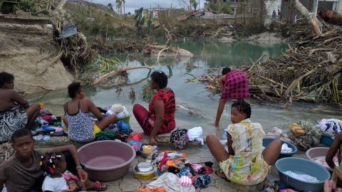 Haitian women and children gather in Port Salut to wash clothes after the devastating effects of Hurricane Matthew. 