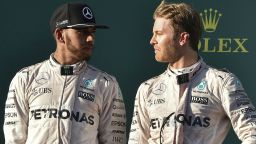 Mercedes AMG Petronas F1 Team's German driver Nico Rosberg (R) talks to his teammate British driver Lewis Hamilton on the podium during the Formula One Australian Grand Prix in Melbourne on March 20, 2016.  / AFP / SAEED KHAN / IMAGE RESTRICTED TO EDITORIAL USE - STRICTLY NO COMMERCIAL USE        (Photo credit should read SAEED KHAN/AFP/Getty Images)
